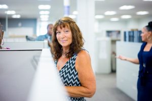 Employee standing outside of cubicle