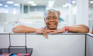 Employee standing over cubicle