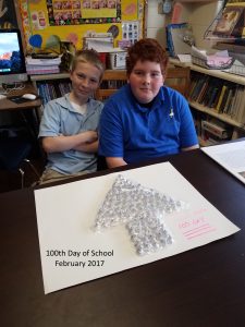 Two Adaire sixth grade students with a 100th day of school presentation made of 100 hershey's kisses candies.