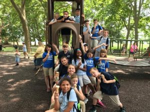 Adaire students posing on playground equipment at a local park.