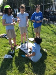 Adaire students working together to build a paper tower for STEM day.