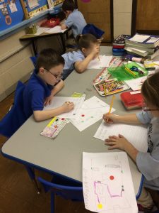 Kindergarten students working on writing in their classroom.