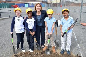Principal Jenkins and several Adaire students pose for a photo during the ground breaking ceremony for the new school yard.