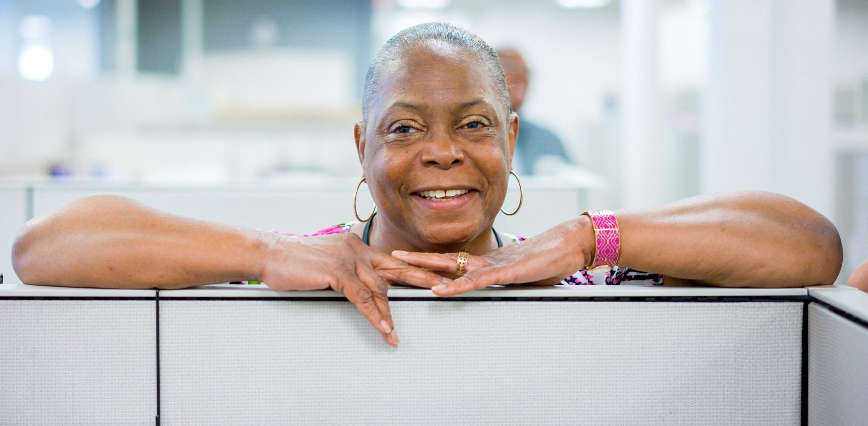 staff; smiling; arms/head over cubicle