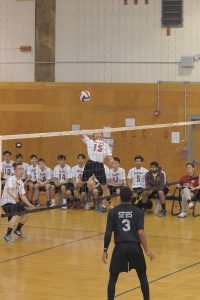 Volleyball player jumping at the net