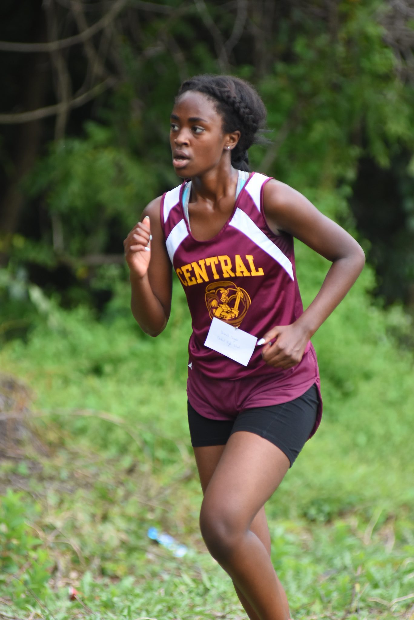 Girl running cross country facing left