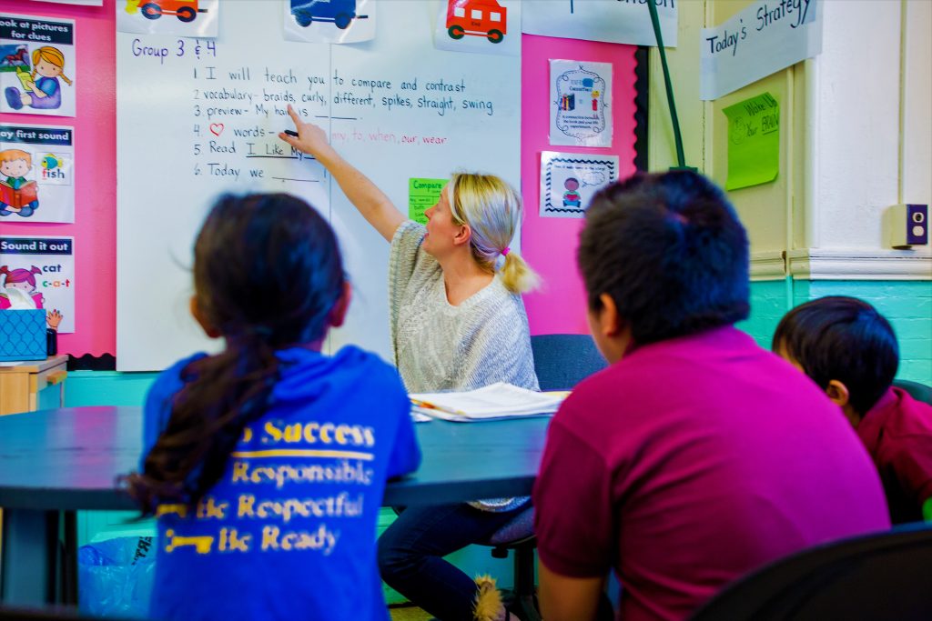 Teacher giving lesson to students