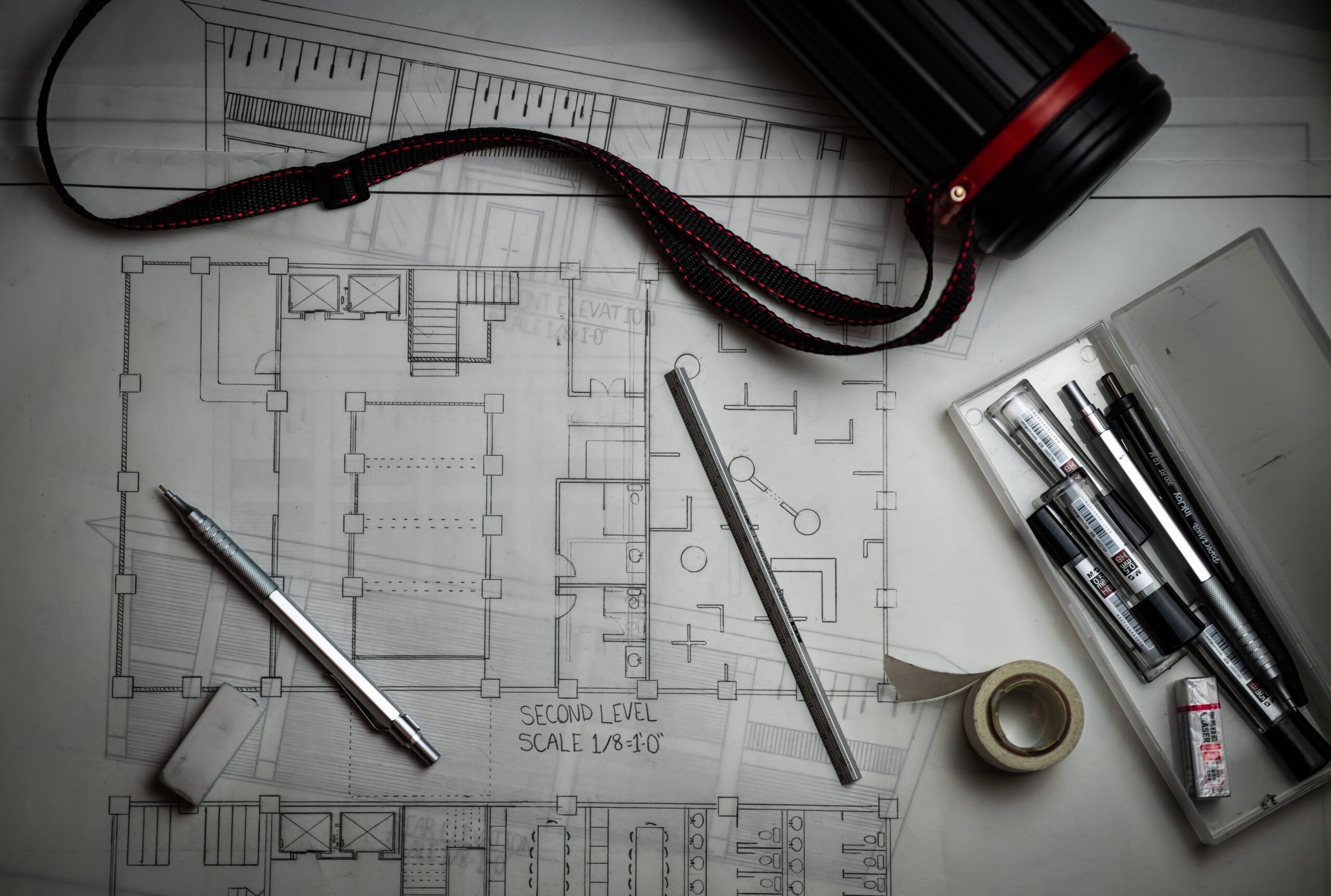 top-down view of a floor plan, with drafting pencils strewn about
