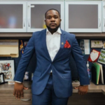 Keith Pretlow standing confidently against an office desk