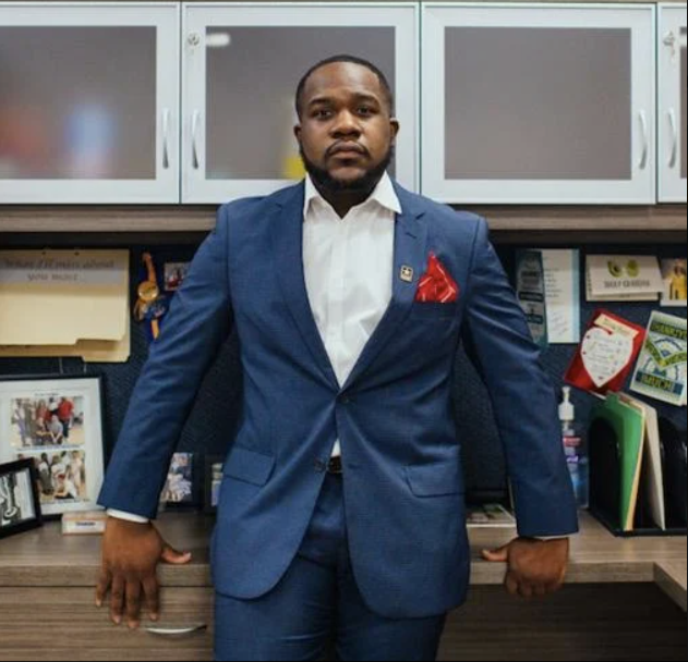 Keith Pretlow standing confidently against an office desk