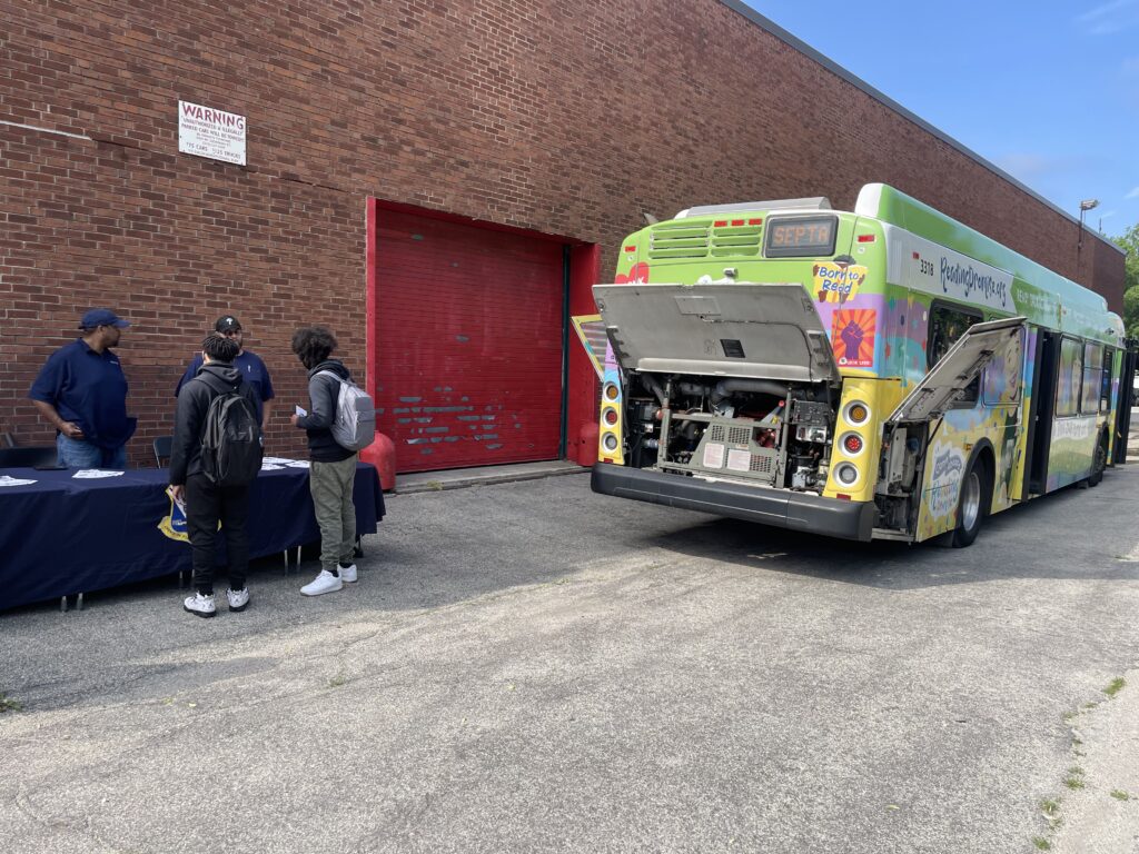 the backside of a SEPTA bus with its backplate open for demonstration/display purposes