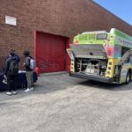 the backside of a SEPTA bus with its backplate open for demonstration/display purposes