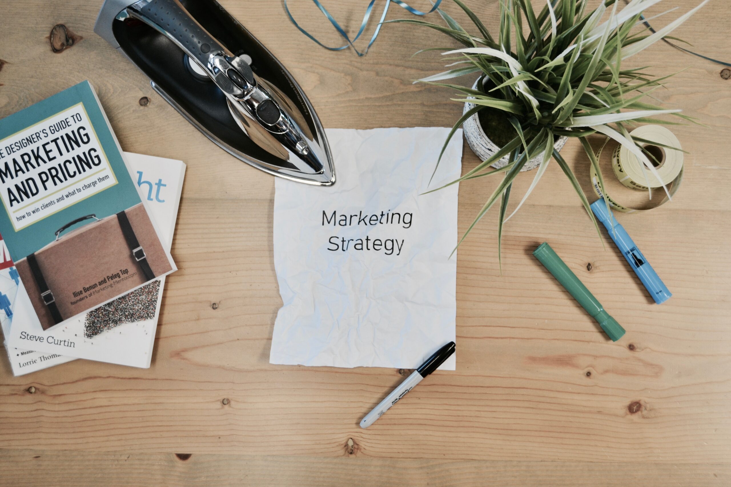 paper on desk with text that reads "marketing strategy"