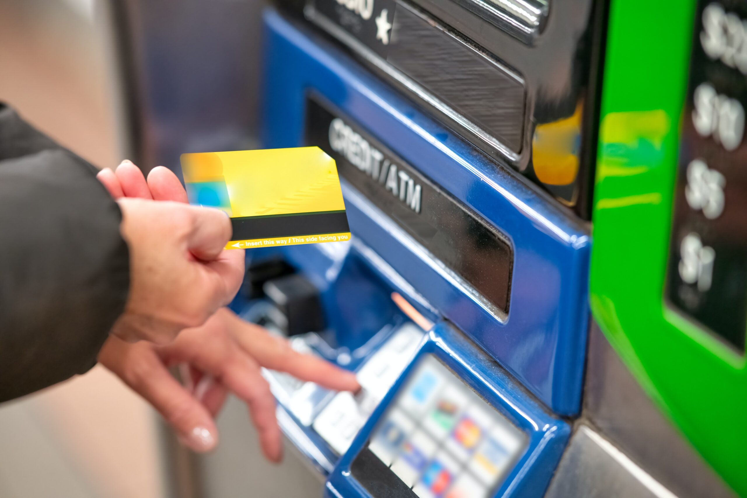 giovanni-gagliardi-b1omwFGldMU-unsplash close up of a person at a machine that refills credits in their card