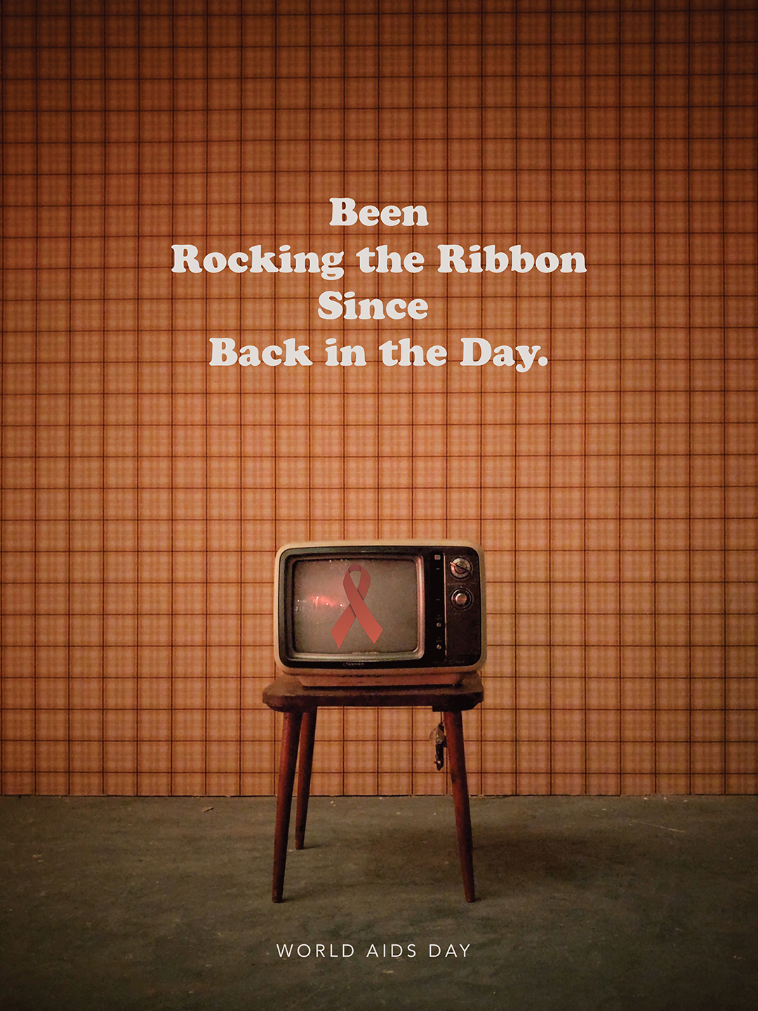 text reads: Been Rocking the Ribbon Since Back in the Day. There is an old-fashioned tv. There is a red ribbon on the tv screen
