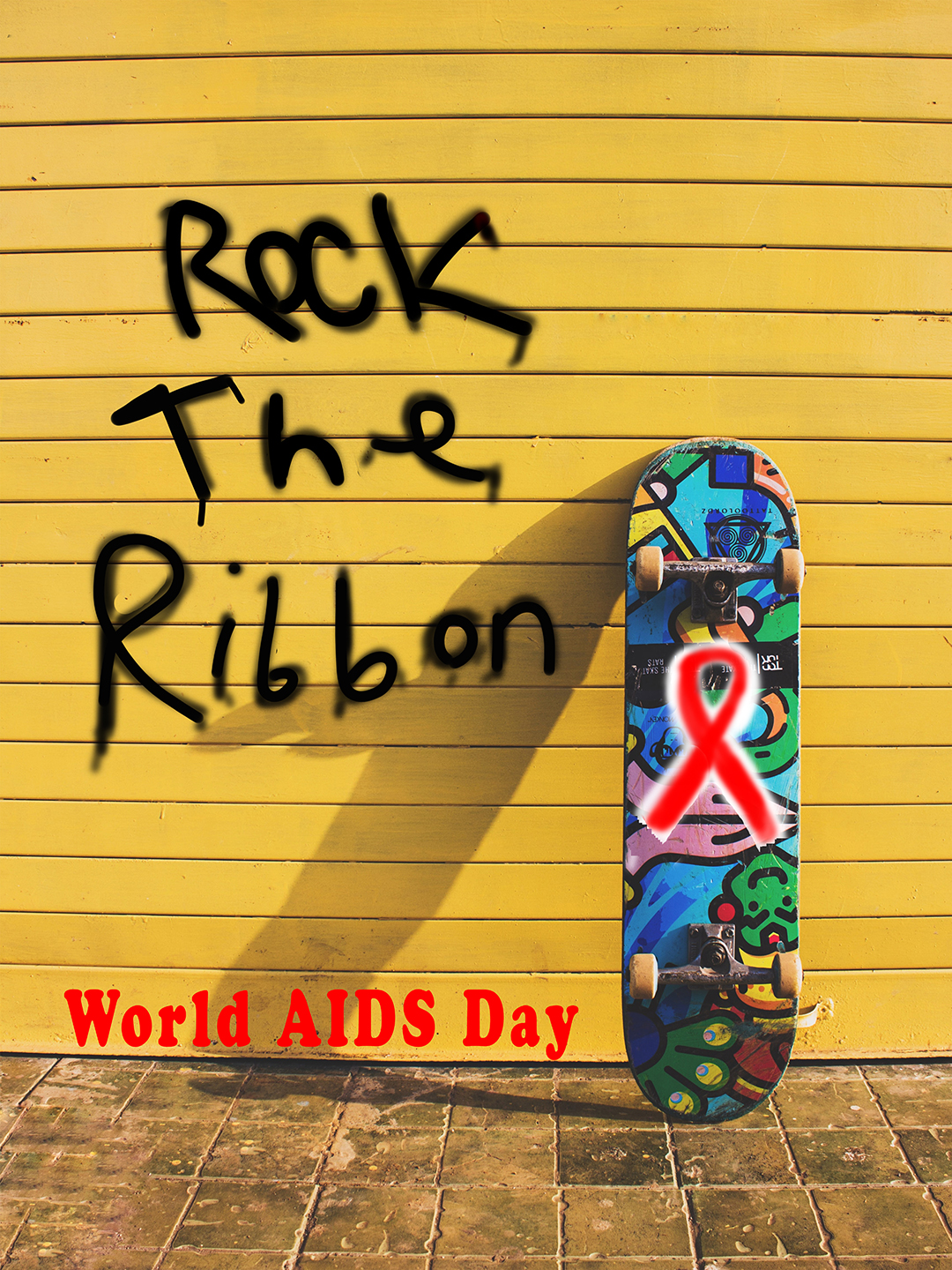 A skateboard leaning against a garage door. Spray painted on the garage is "Rock The Ribbon"