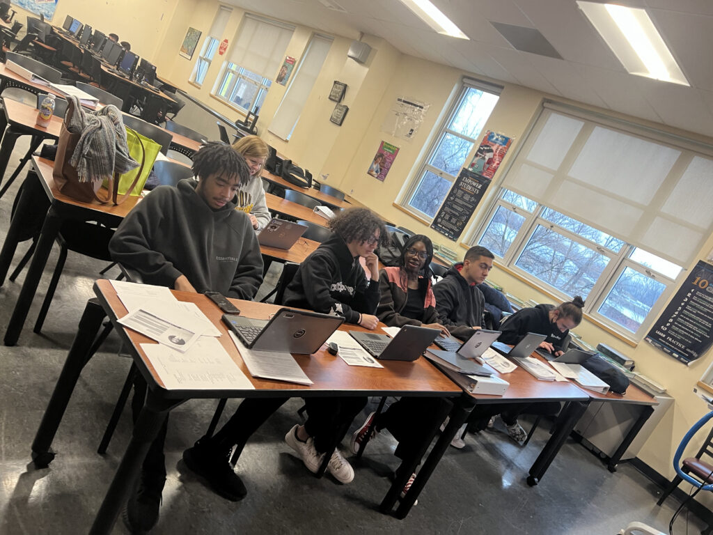 five Lincoln HS students sitting in line at classroom desks