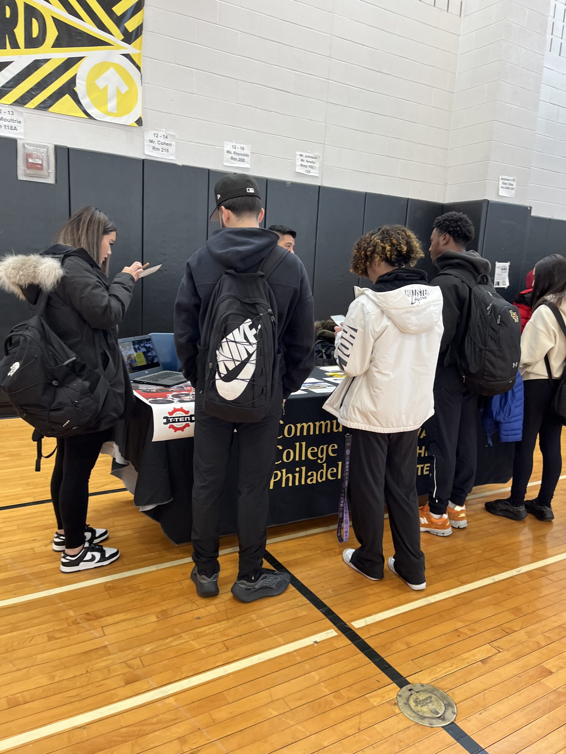 students at Lincoln HS speaking to a representative from Community College of Philadelphia during the Trade & Union Fair @ Lincoln HS