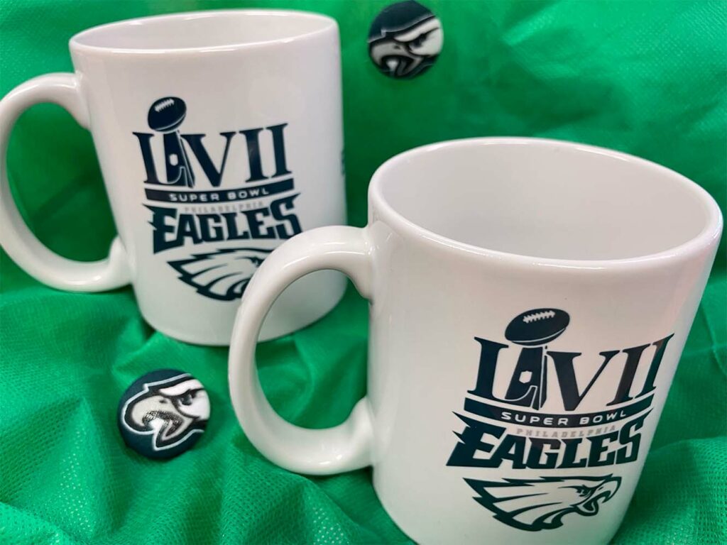 White ceramic mugs that have the print "LVII EAGLES" and the Eagles football team logo