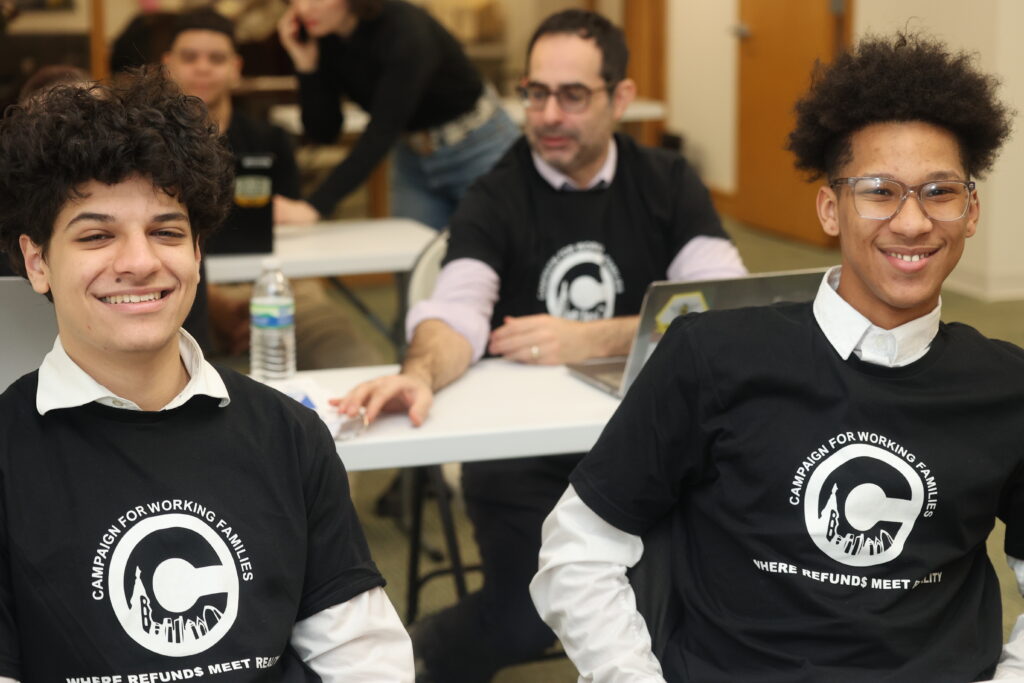 Two Northeast Highschool students smiling, wearing Campaign for Working Families volunteer shirts.