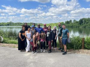The Equity Team standing in front of a lake at the Discovery Center