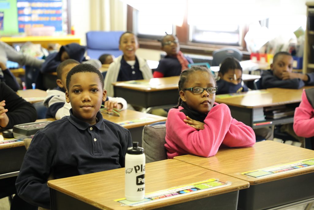 Students sit at desks