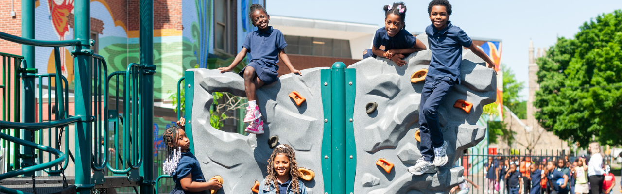 Students playing on climbing equipment on an outdoor school playground