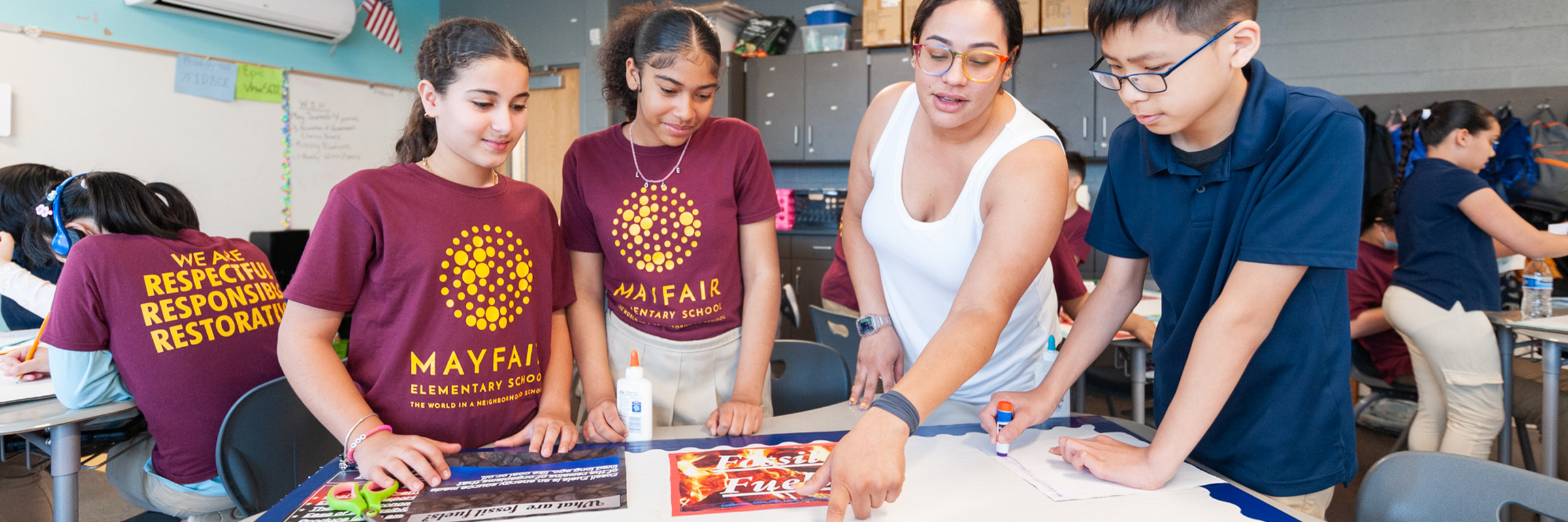 Teacher showing three students math”
