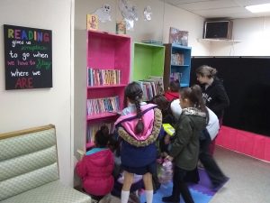 Students pick out books from the new community library