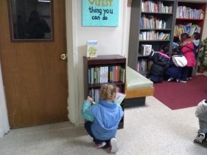 Students pick out books from the new community library
