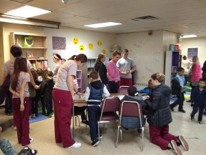 Volunteers help students pick out books