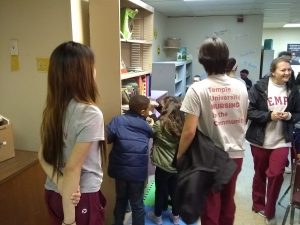 Volunteers help students pick out books