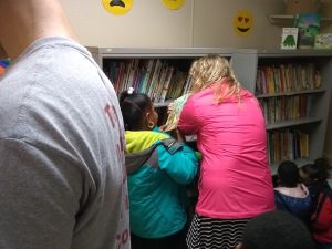 Volunteers help students pick out books