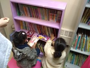 Children pick out books at the new community library