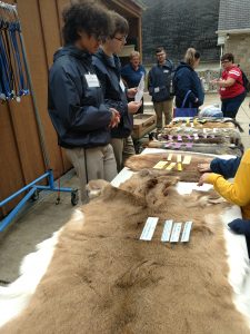 Tour Guides showing pelts to students