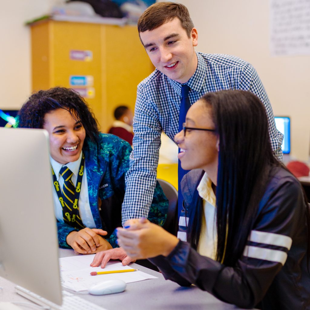 Teacher and student at computer