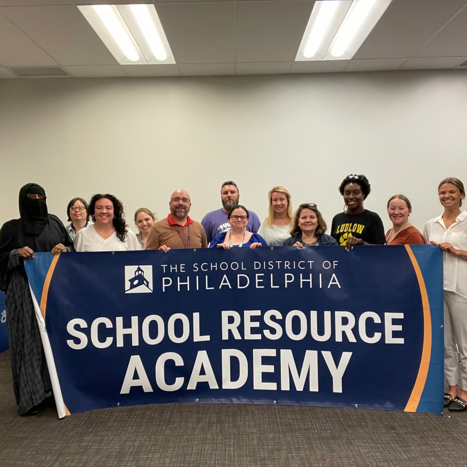 School Resource Academy students standing in a ground holding a banner