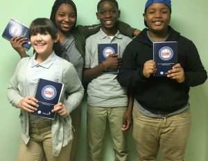 8th grade students with their SCORE journals