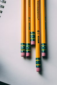 pencils laying on a notebook