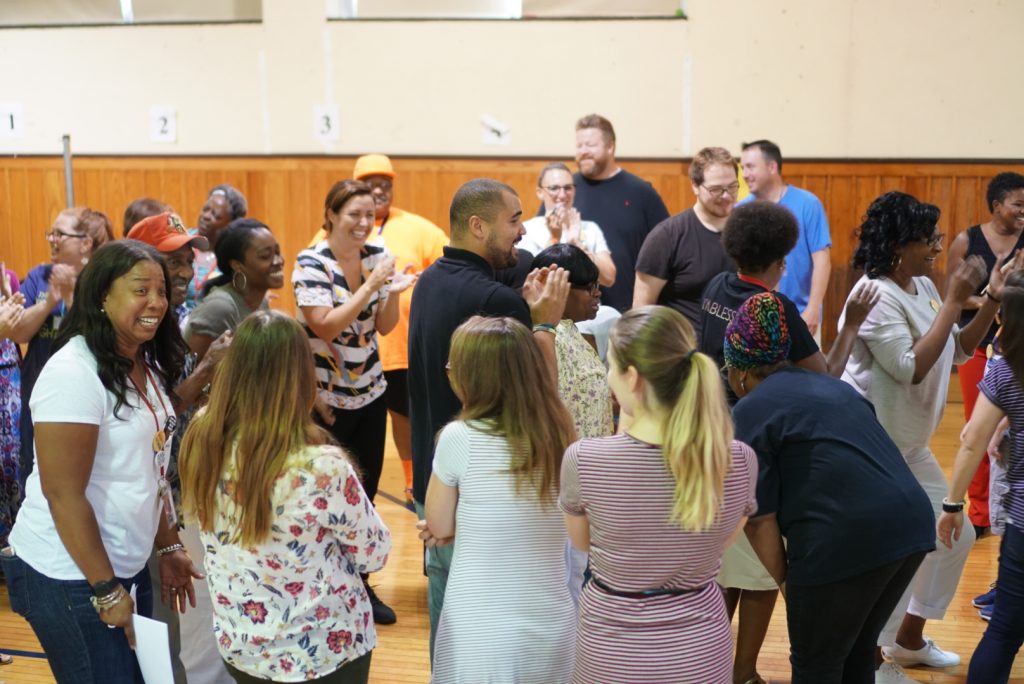 OEC staff gathered in a circle smiling