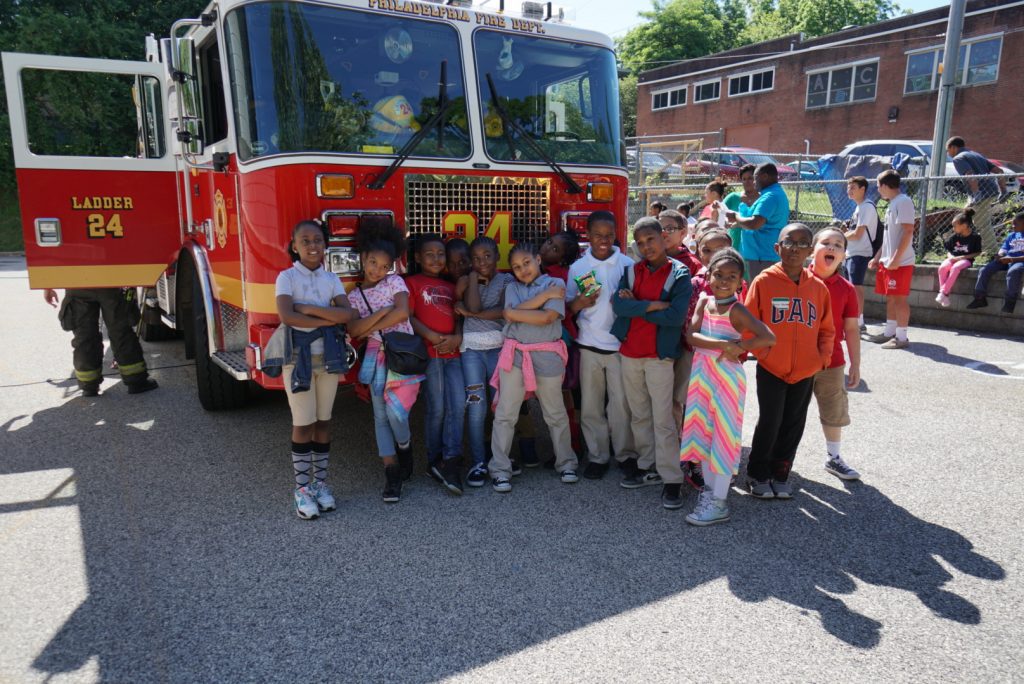oec students in front of a fire engine