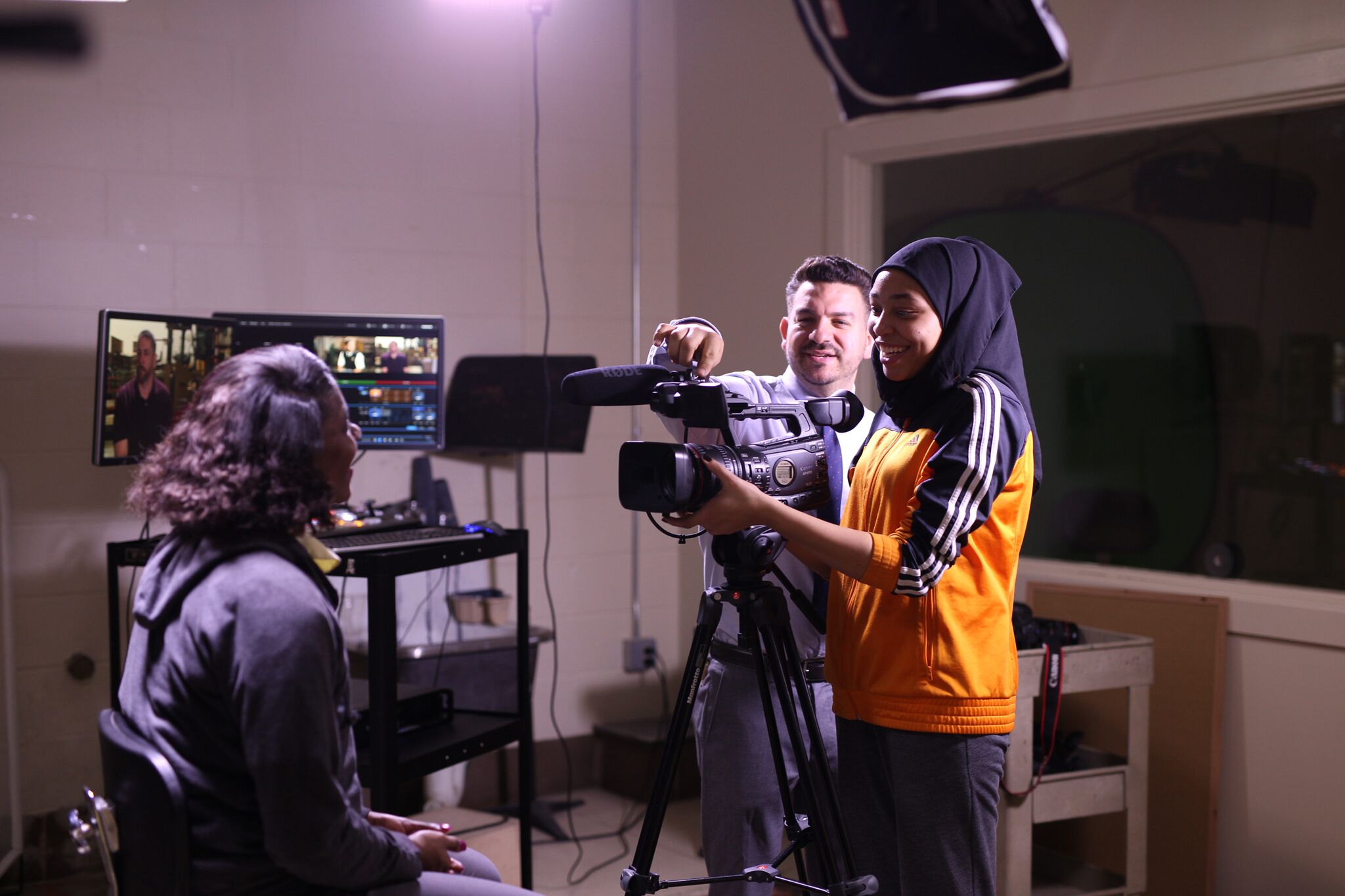 Students working with a camera with teacher