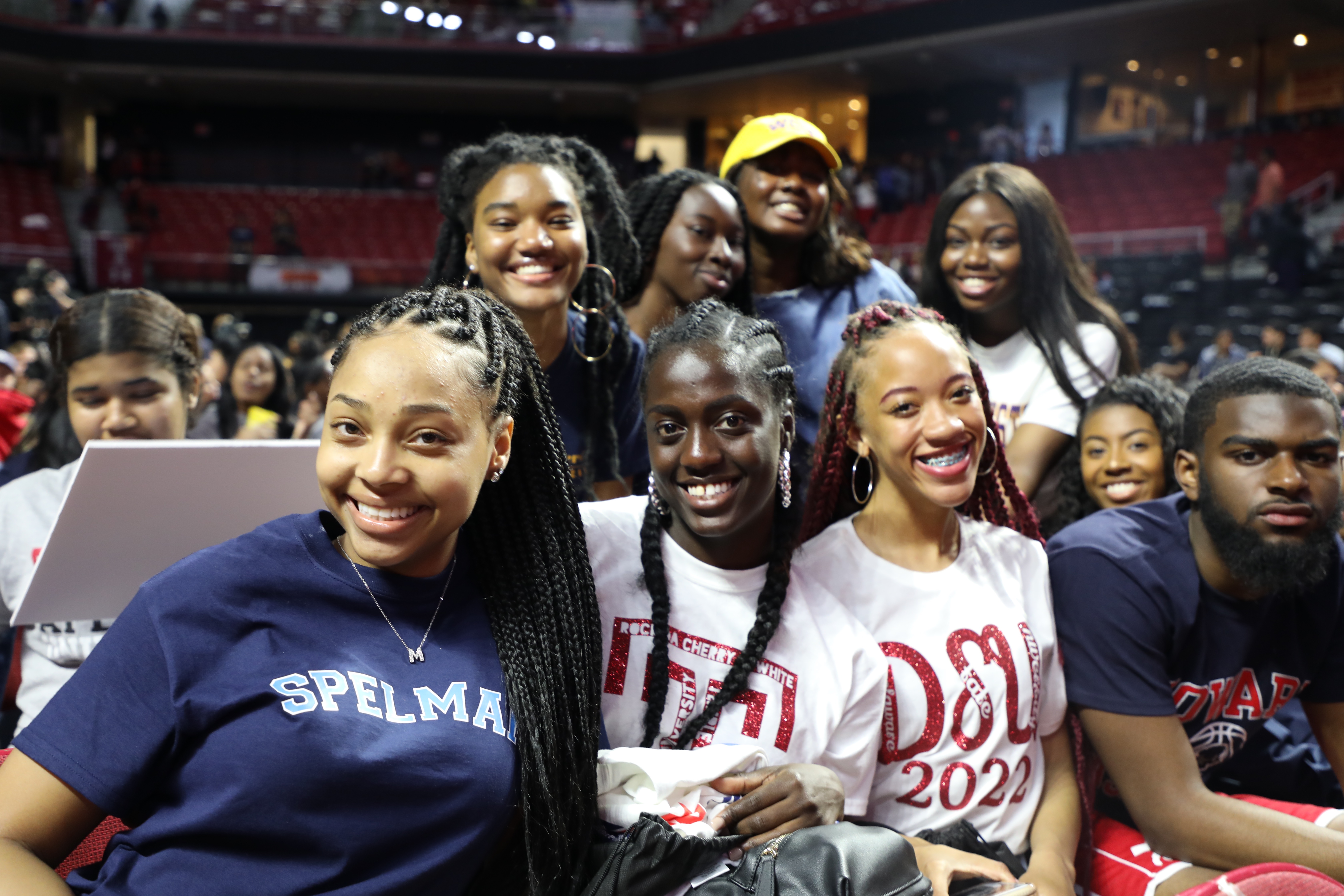 Students smiling with college gear