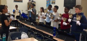students playing handbells