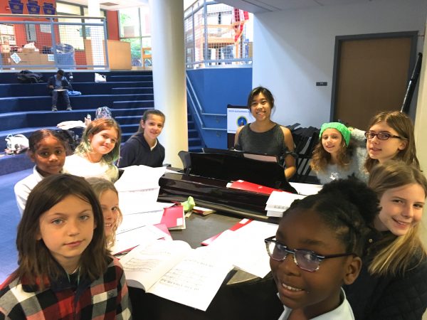 CHOIR1 students at piano during choir practice