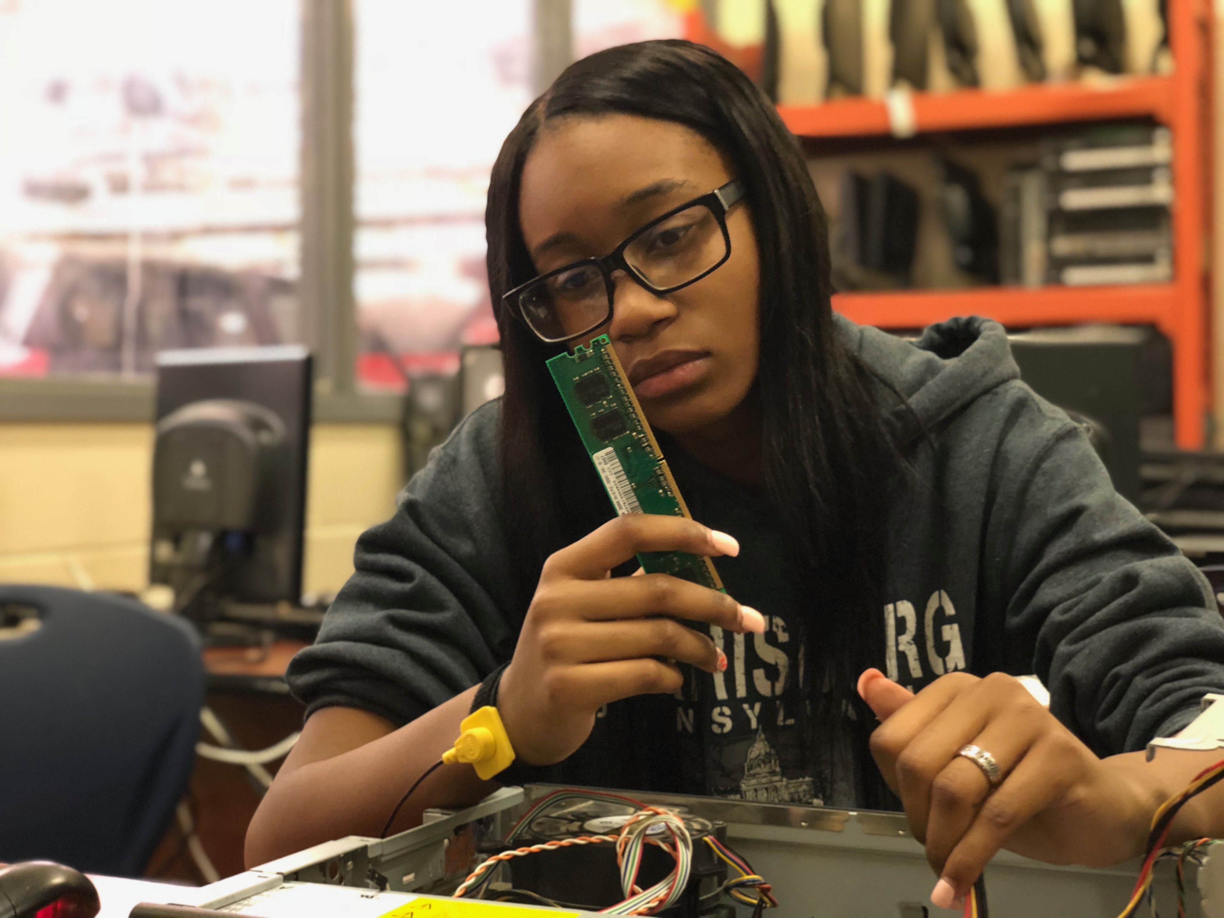 Vending students working with electronic components. 