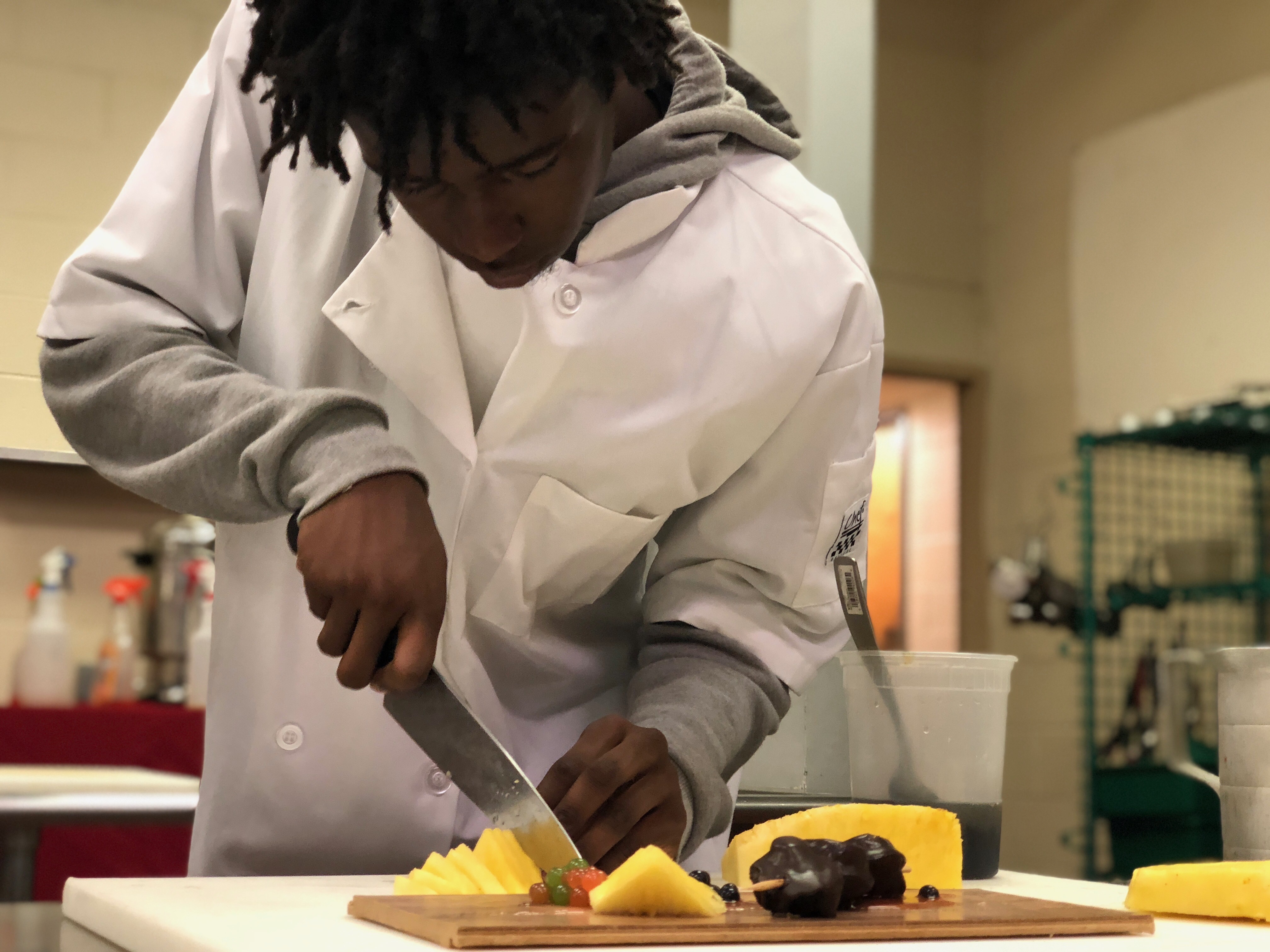Students learn to prepare fresh ingredients for the kitchen.