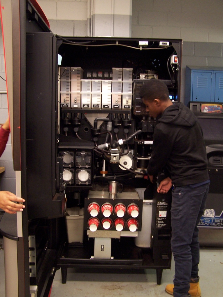 Students working on a coffee vending machine. 