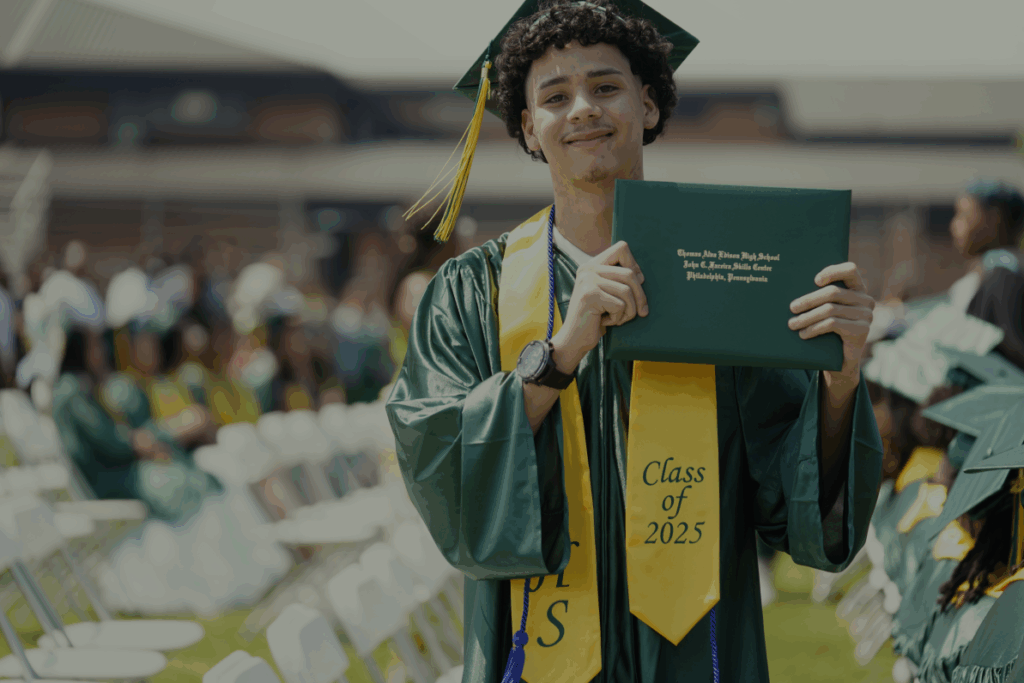 SDP Class of 2025 graduate holds up his diploma after the graduation ceremony