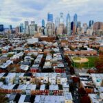 An aerial view of Center City Philadelphia with a neighborhood of rowhomes and baseball field in the foreground